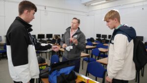 Two brickwork students look at brickwork equipment