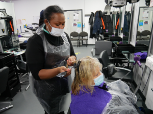 Hairdressing student provides a conditioning treatment for a NHS keyworker