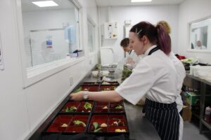 Students preparing salad boxes at Royal Ascot