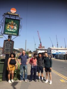 Picture of the students from Reading College and their tutor Edward Christie outside the New Beginnings Reading All Day Cafe on Great Knollys Street. (Left to right: Juliana Padinho Koscheck, English teacher Edward Christie, Myles Beckles-Fiedkow, Romeo Malcon and Miran Pardehdar).