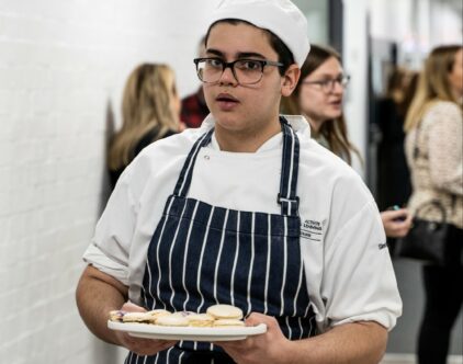 Hospitality Level 2 student serving canapes 