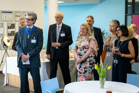 A crowd of staff and civic dignitaries at a Coronation Cocktails event