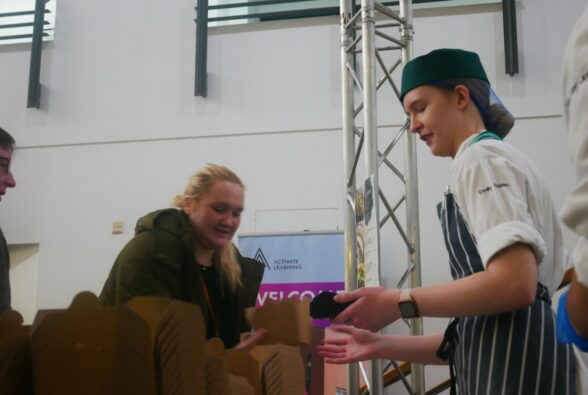 Emily, a Professional Culinary Arts student serves food to a hungry member of staff 