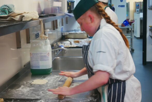 Lexi Harrison, a Professional Culinary Arts student, prepares food for the Street Food event. 