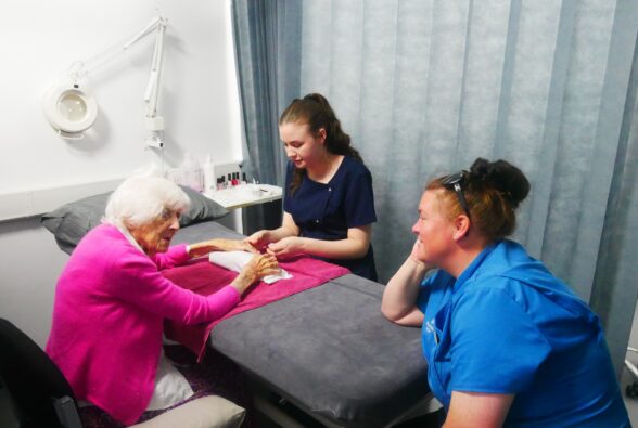 Holly McAlister, a Level 1 Hair and Beauty student gives Audrey, a resident at Shinfield View Care Home a manicure. Laura Mc Soley, Events Manager at Shinfield View Care Home also pictured.