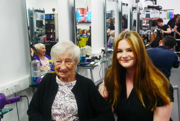 Maureen, a resident at Lakeside Care Home with Tia-Iris Whinnerah, a Hairdressing Level 3 student who blow dried her hair 
