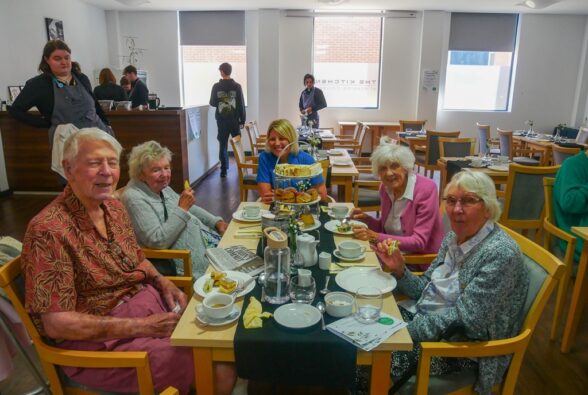 Shinfield Care Home residents Rodney, Hazel, Valerie and Audrey and a member of staff enjoy Afternoon Tea in The Kitchen.