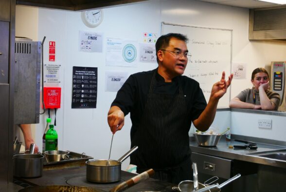 Chef Jay demonstrates how to prepare Thai cuisine to students during the masterclass. 