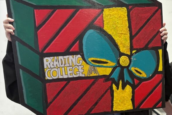 Picture of the Christmas present-themed wooden board created by three students studying a Foundation Creative Crafts Pathway at Reading College and University Centre.