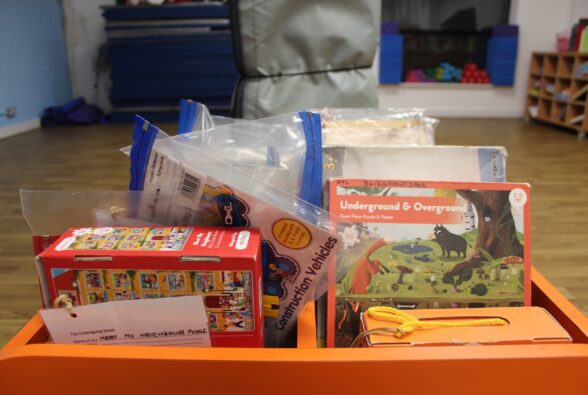 Activity toys in a orange bookcase