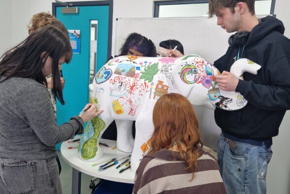 Students working on the elephant sculpture