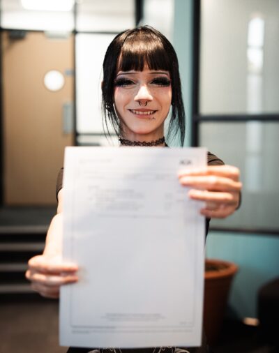 A female student holding her results